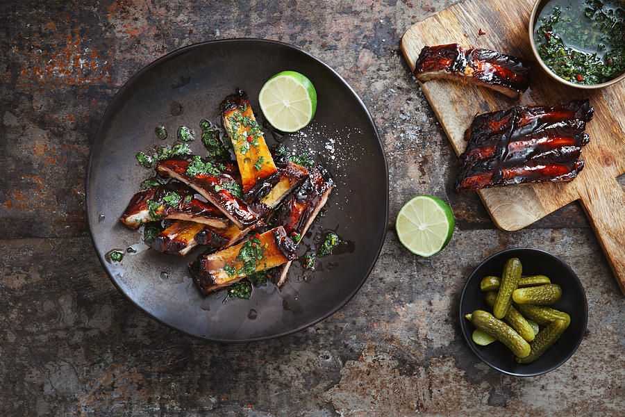 Pomegranate and red wine glazed pork ribs with chimichurri sauce Photograph by Eugene Mymrin