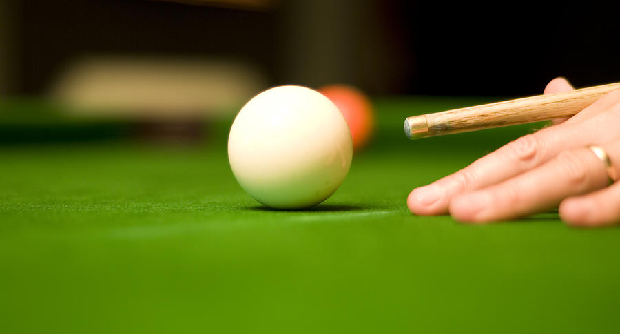 Pool player with cue poised to hit cue ball Photograph by Mutenagen