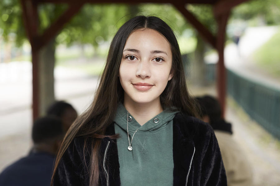 Portrait confident female teenage girl at park Photograph by Maskot
