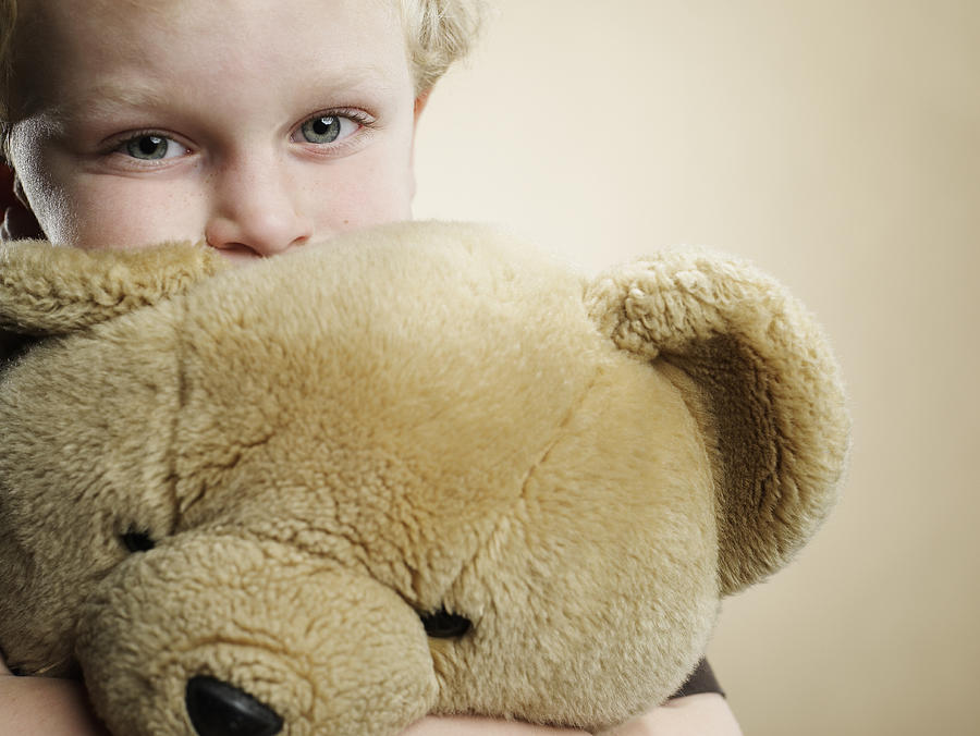 Portrait of a 6 year old boy hugging teddy bear Photograph by Ryan McVay