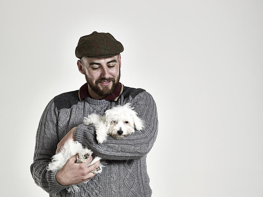 Portrait of a bearded male happily holding a puppy Photograph by Jamie Garbutt