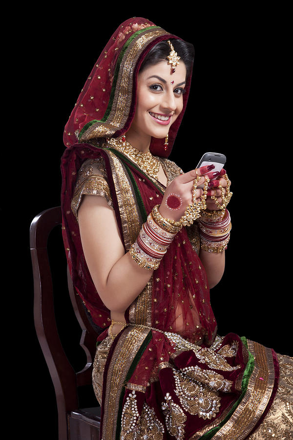 Portrait of a beautiful bride with a mobile phone Photograph by Sudipta Halder