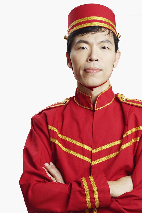 Portrait of a bellhop with his arms crossed Photograph by Red Chopsticks