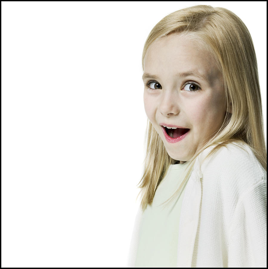 Portrait Of A Blonde Female Child As She Flashes A Surprised Look At The Camera Photograph by Photodisc