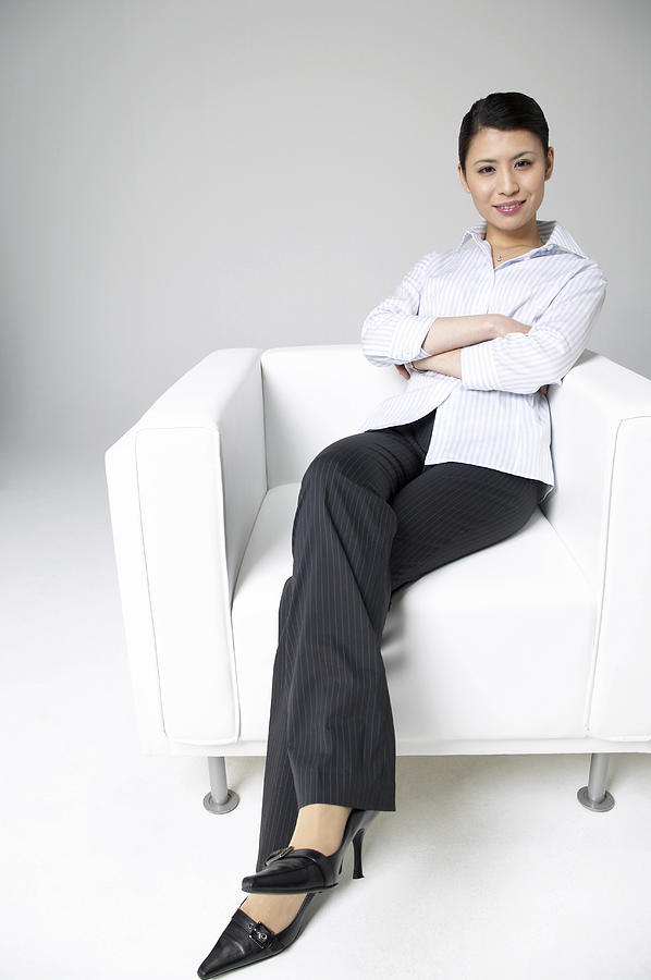 Portrait of a Businesswoman Sitting in an Armchair With Her Arms Crossed Photograph by Mash
