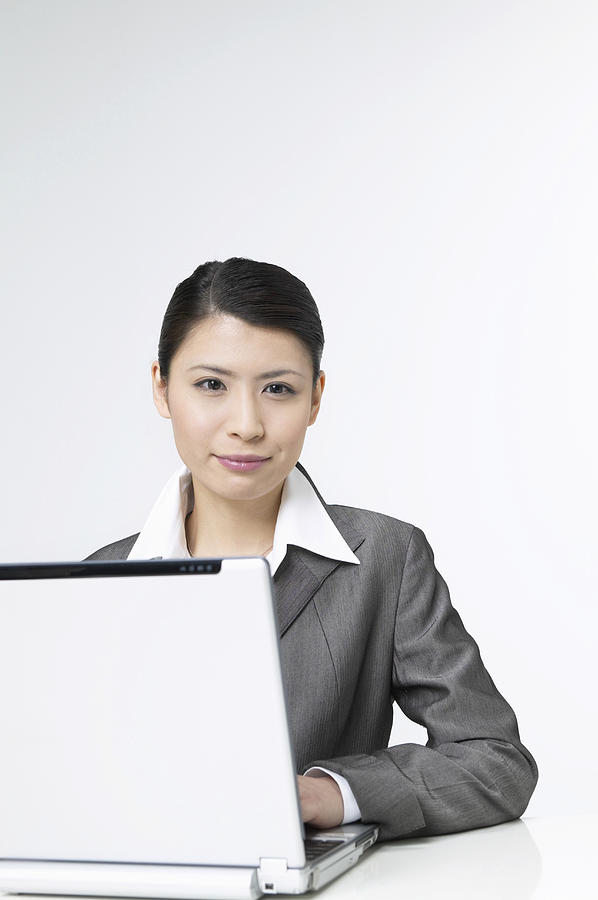 Portrait of a Businesswoman Sitting With a Laptop Photograph by Mash
