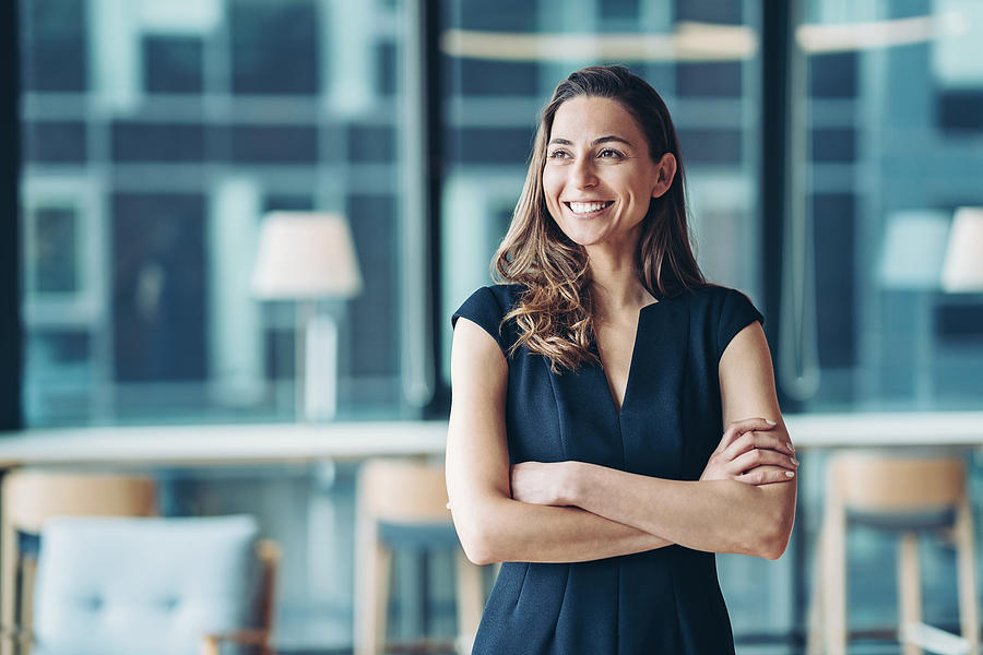 Portrait of a businesswoman standing in a a modern office Photograph by Pixelfit