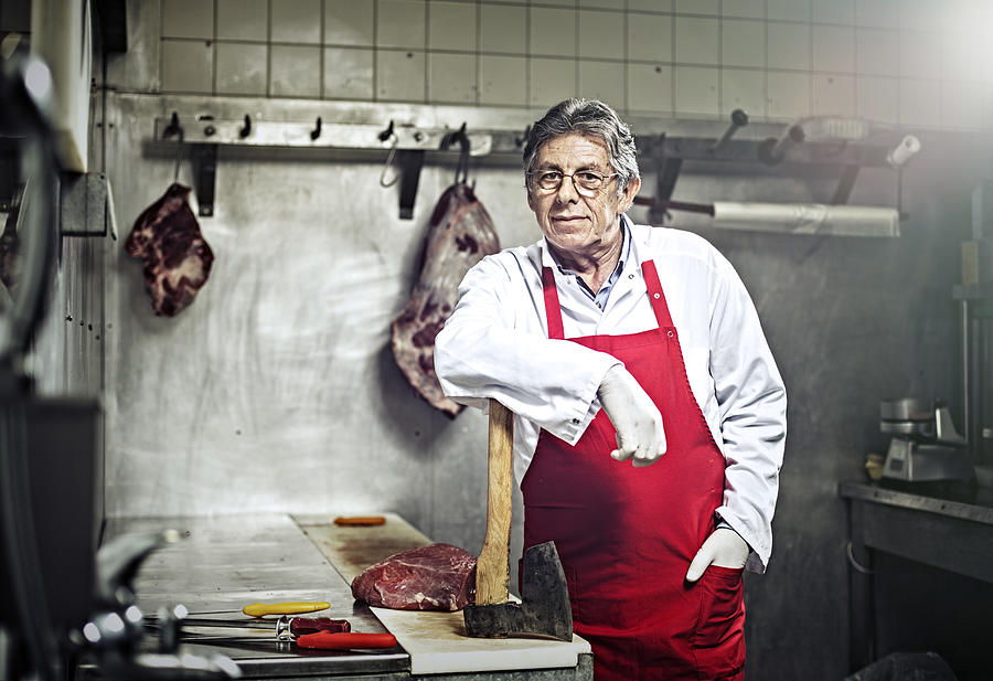 Portrait of a Butcher Standing in a Butchers Shop Photograph by Poba