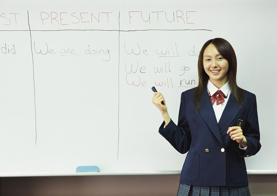 Portrait of a College Student Standing by a White Board in a Classroom Photograph by Digital Vision.