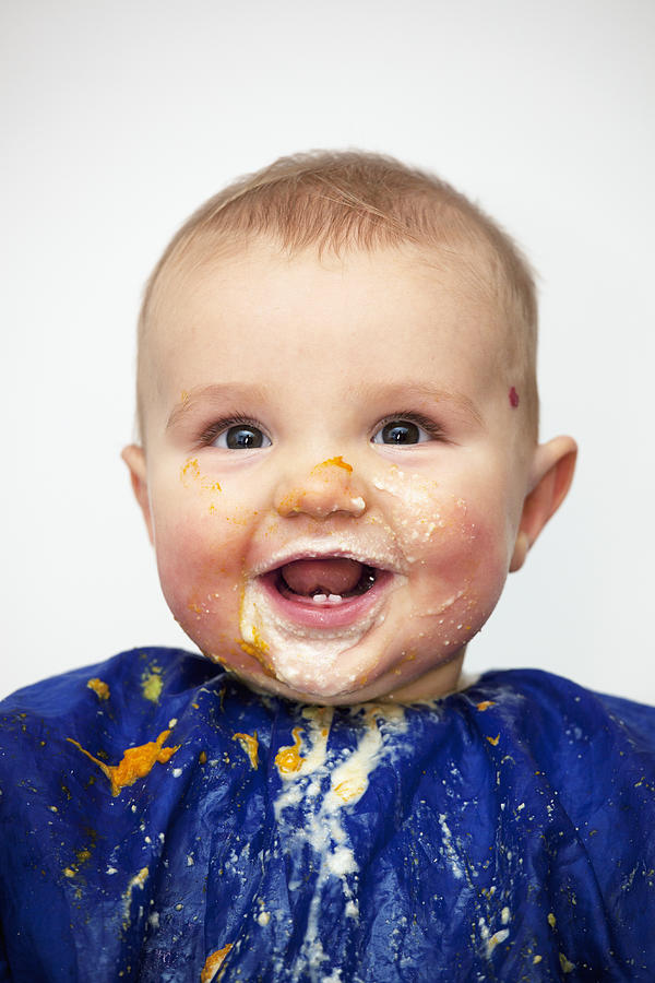 Portrait of a happy baby boy covered in food Photograph by Tobias Titz