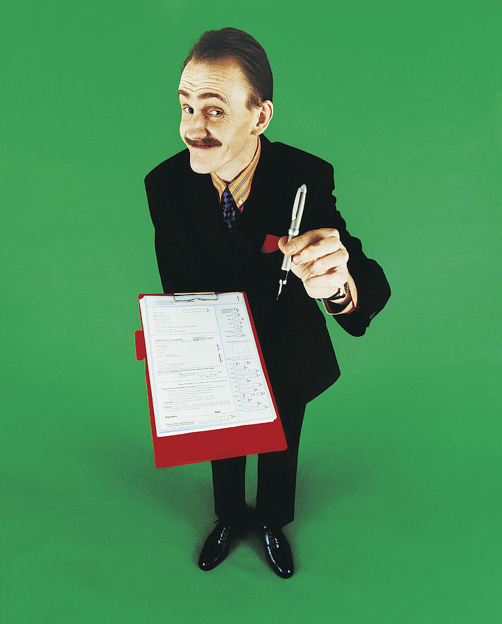 Portrait of a Market Researcher Holding a Fountain Pen and a Questionnaire Photograph by Digital Vision.