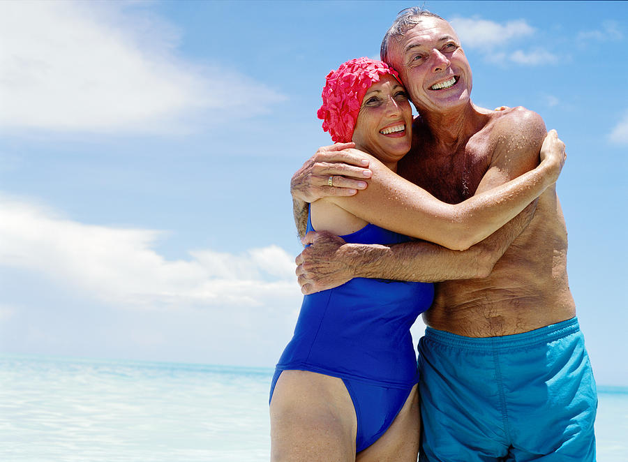 Portrait Of A Mature Couple Hugging Each Other At The Beach Photograph by Stockbyte