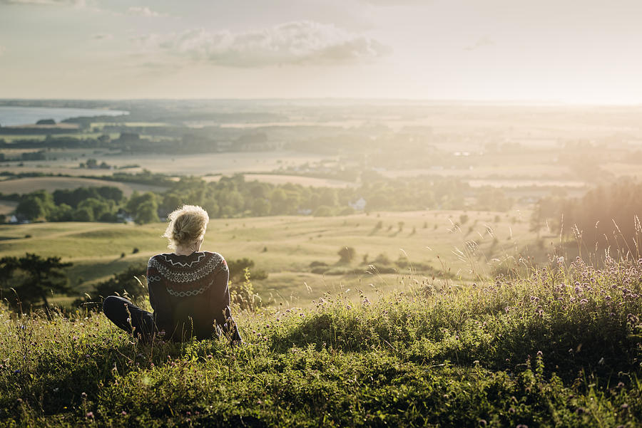 Portrait of a mature woman looking out over the countryside. Photograph by ClarkandCompany