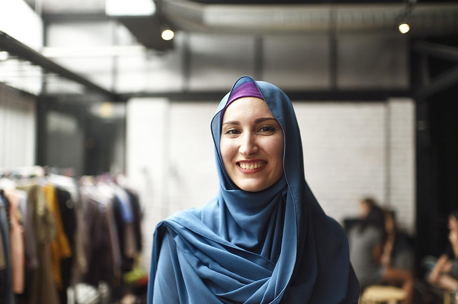 Portrait of a Muslim woman in a clothing store Photograph by Carlina Teteris