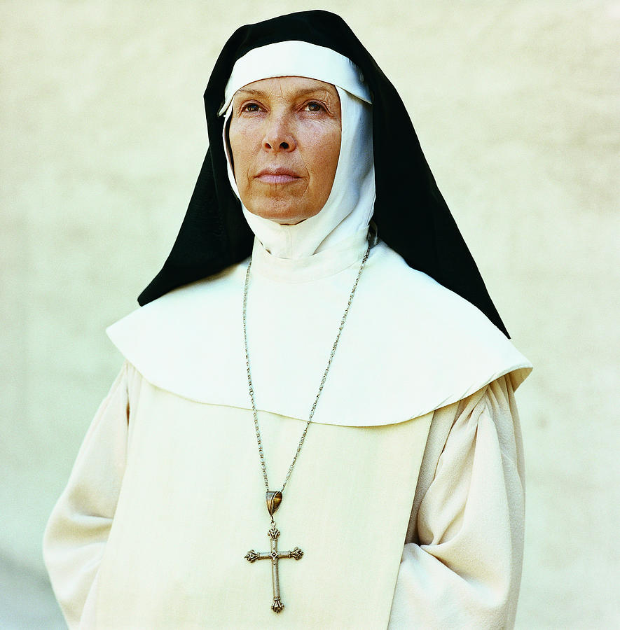 Portrait of a Nun Wearing a Crucifix Photograph by Digital Vision.