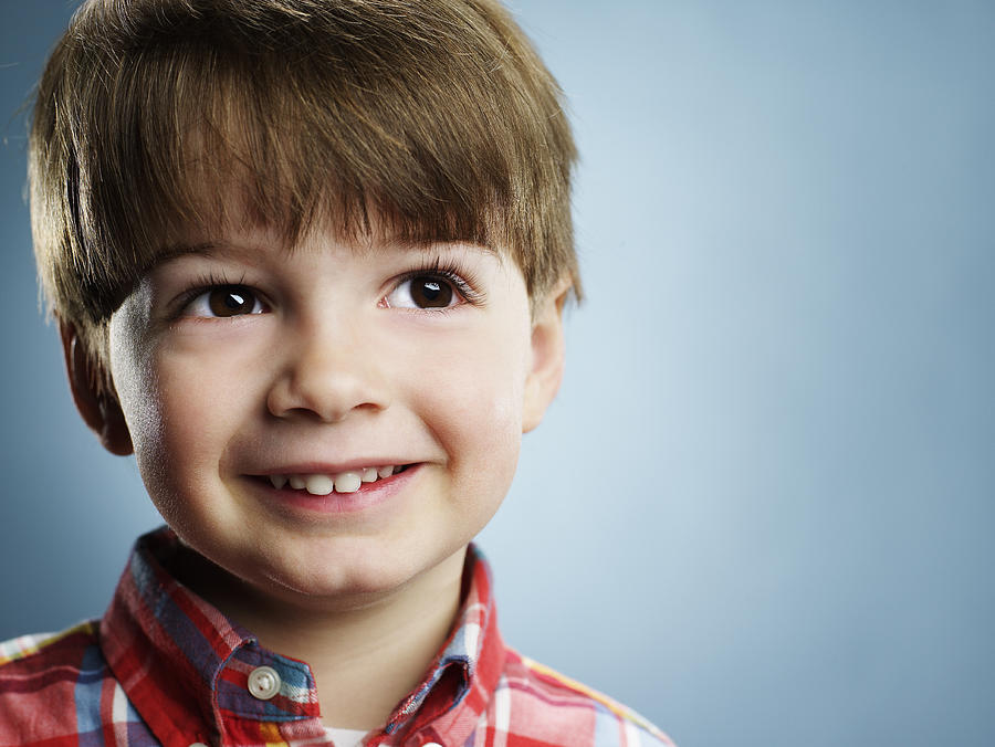 Portrait of a smiling 3 year old boy.  Photograph by Ryan McVay