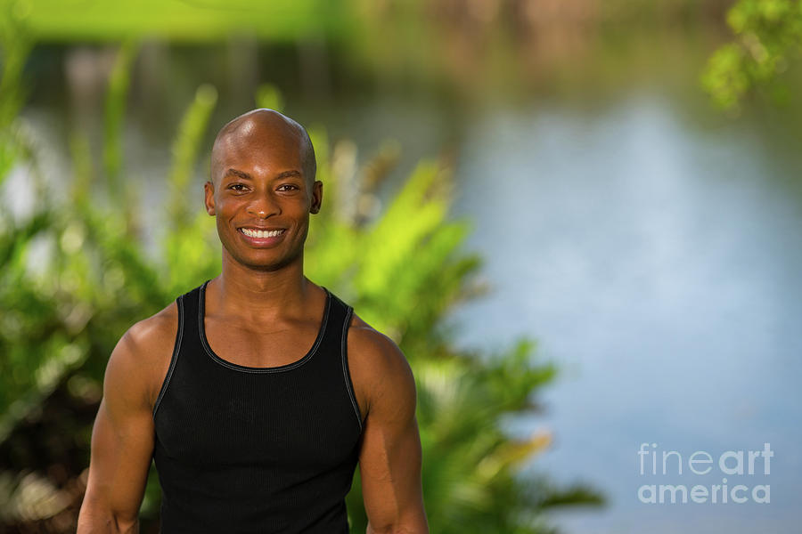 Portrait Of A Smiling African American Fitness Model Posing Outd