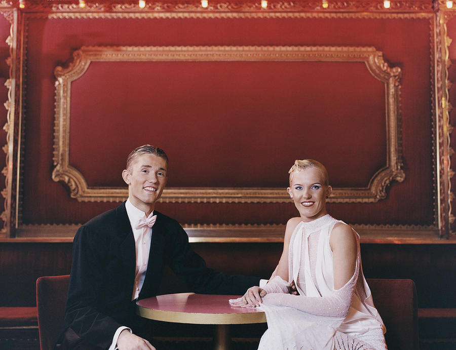 Portrait of a Smiling Ballroom Dancing Couple Sitting at a Table Photograph by Digital Vision.