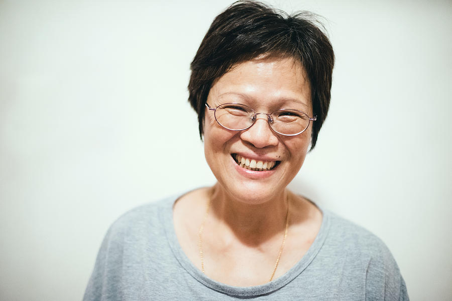 Portrait of a smiling middle age chinese woman Photograph by images by Tang Ming Tung