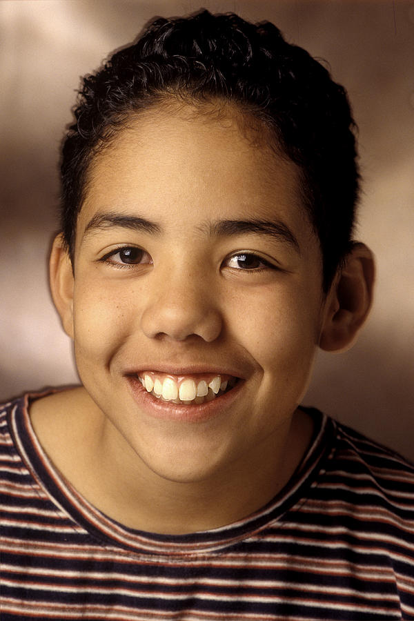 Portrait Of A Teenage Male In A Striped Shirt As He Smilies Brightly At The Camera Photograph by Photodisc