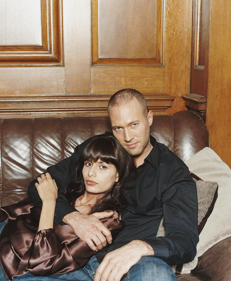 Portrait of a Twentysomething Couple Sitting on a Leather Sofa Photograph by A J James