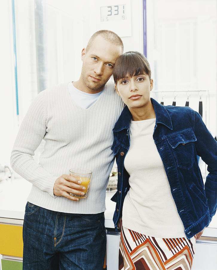 Portrait of a Twentysomething Couple, with the Man Holding a Glass of Orange Juice Photograph by A J James