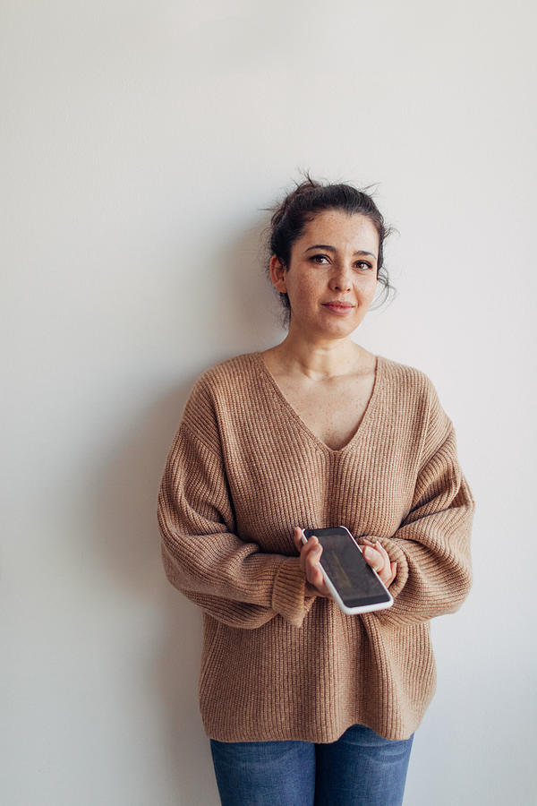 Portrait of a woman holding mobile phone Photograph by AleksandarNakic
