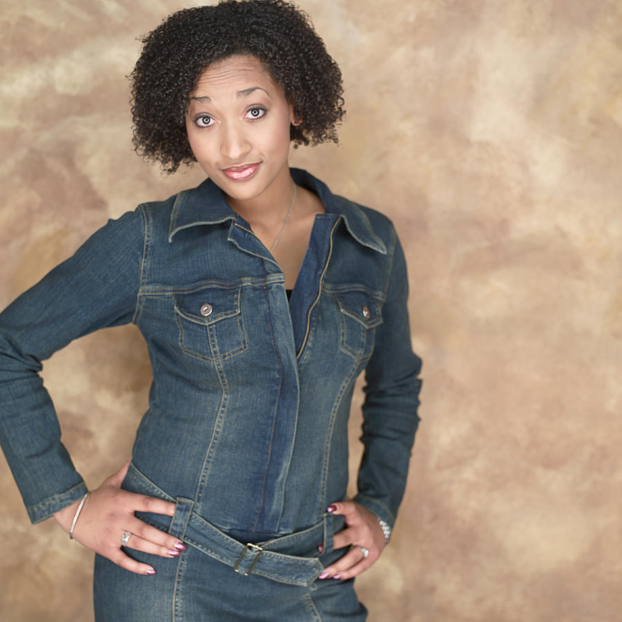Portrait Of A Young Attractive African American Woman In A Denim Outfit As She Flashes Some Attitude Photograph by Photodisc