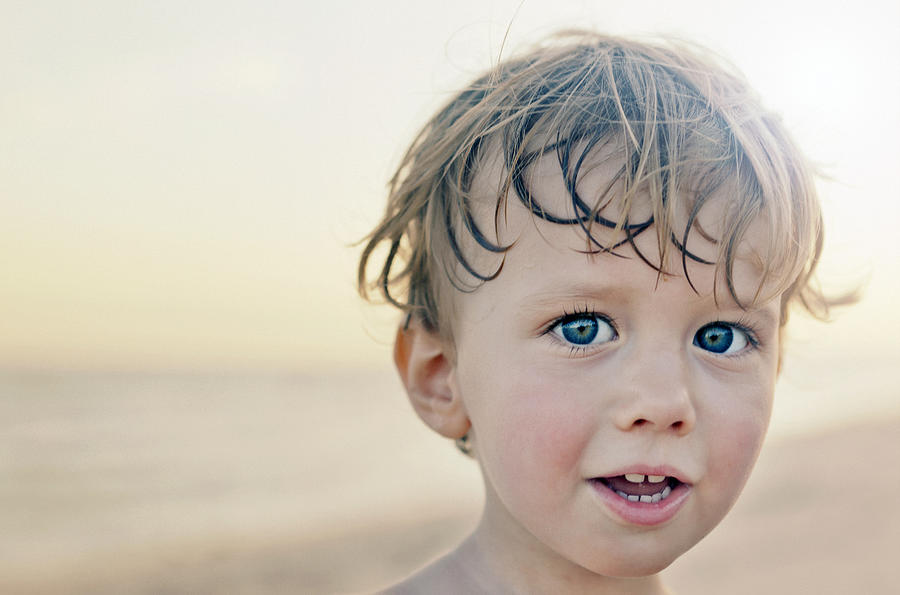 Portrait of a young boy on a beach Photograph by Caroline Purser
