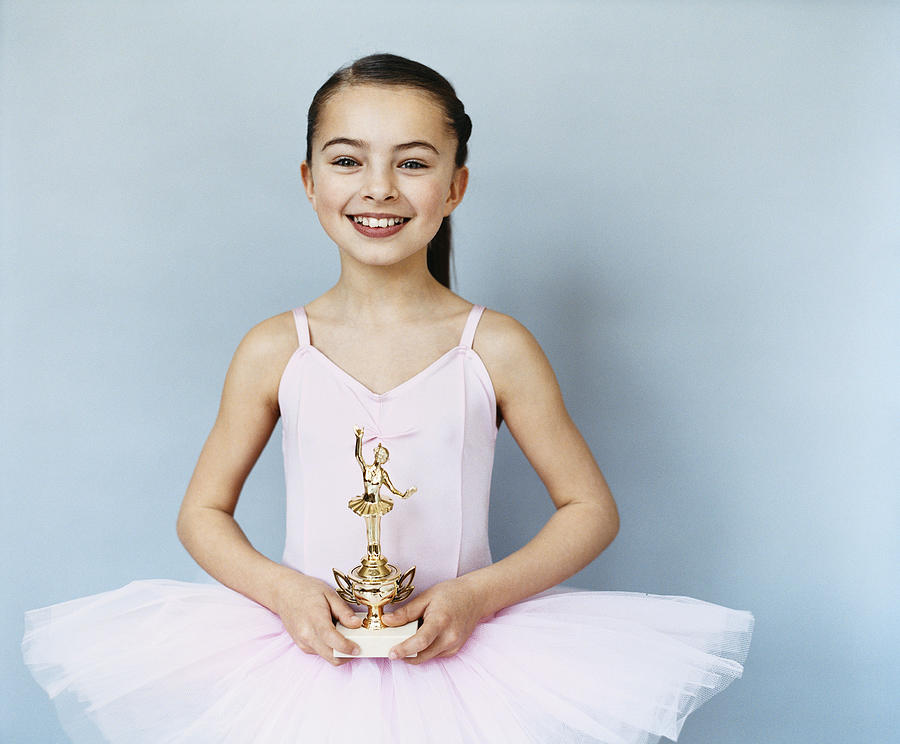 Portrait of a Young, Female Ballet Dancer Holding a Trophy Photograph by Digital Vision.