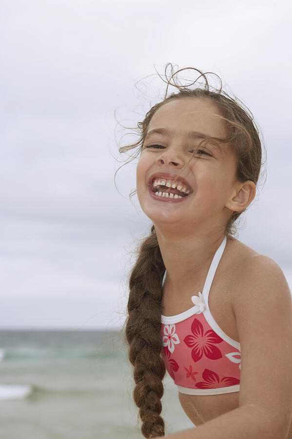 Portrait of a Young Girl in a Bikini Top, Laughing Photograph by Digital Vision.