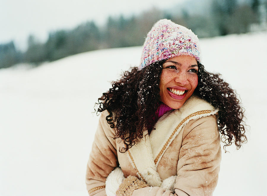 Portrait of a Young Woman Wearing a Hat in the Snow Photograph by Digital Vision.