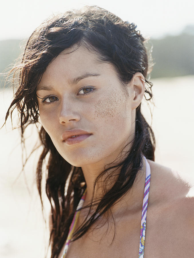 Portrait of a Young Woman With Messy hair and Sand on Her Cheek Photograph by Digital Vision.