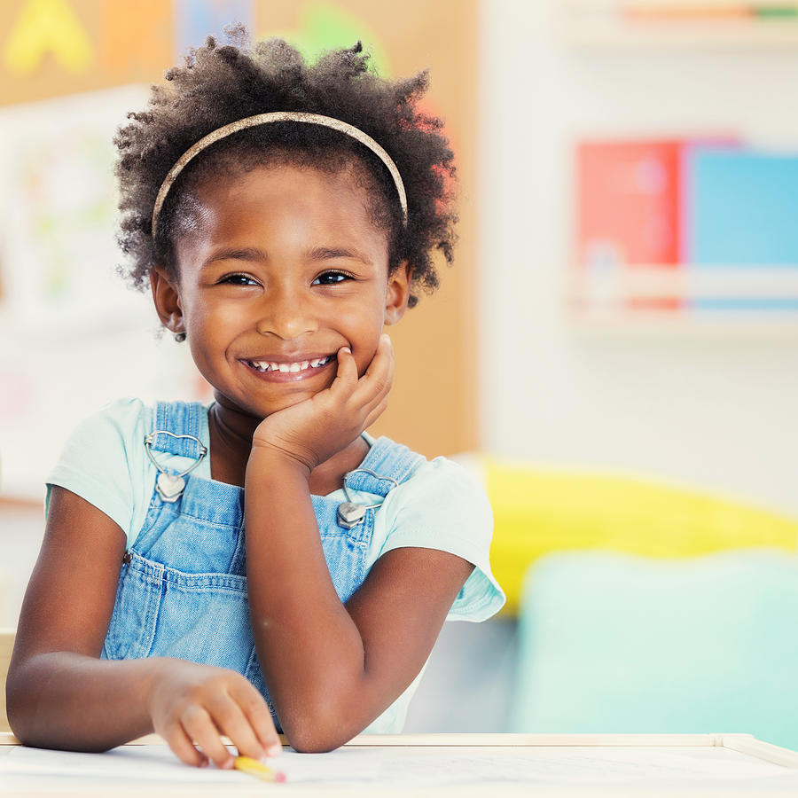 Portrait of adorable preschooler in her classroom Photograph by SDI Productions