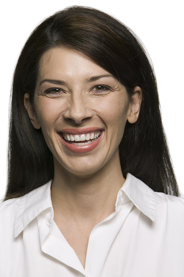 Portrait Of An Attractive Adult Brunette Woman As She Smiles Brightly At The Camera Photograph by Photodisc