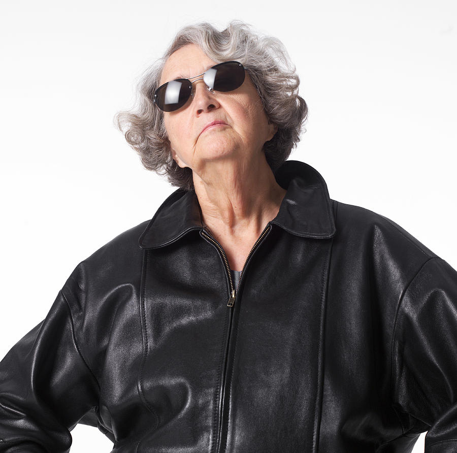 Portrait Of An Elderly Caucasian Woman In A Leather Jacket And Sunglasses As She Throws Her Head Back Confidently Photograph by Photodisc
