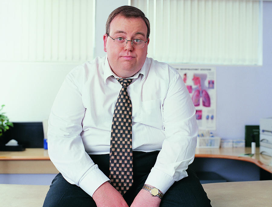 Portrait of an Overweight Businessman in a Doctors Office Photograph by Digital Vision.