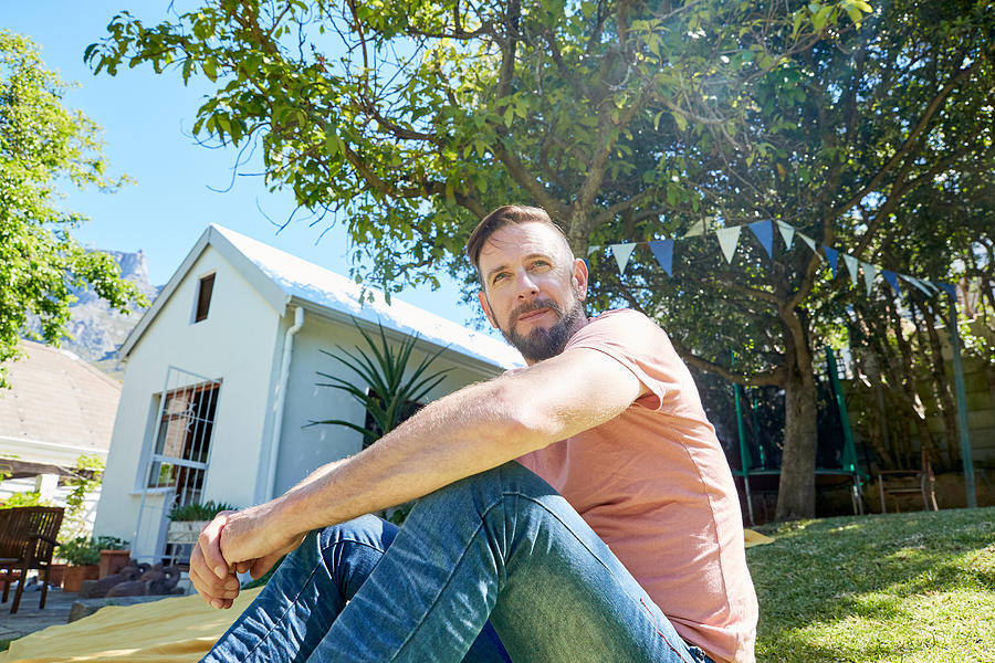 Portrait of bearded man sitting in front of a house Photograph by Westend61