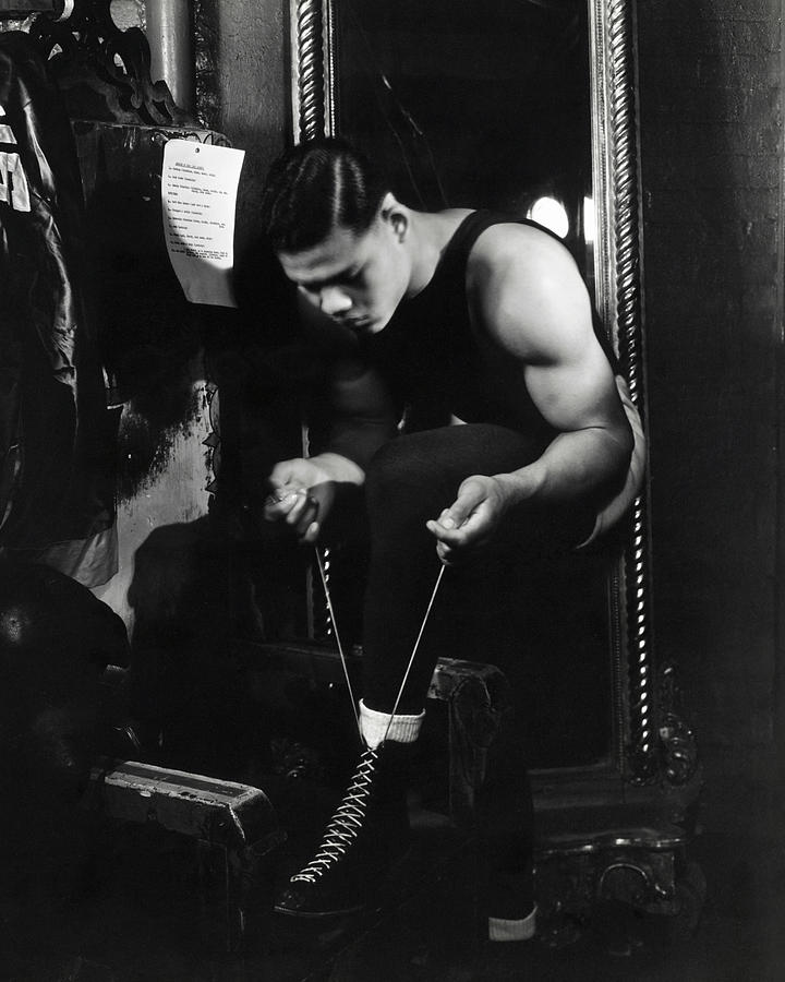 Portrait of Boxer Joe Louis Lacing His Boots Photograph by Lusha Nelson