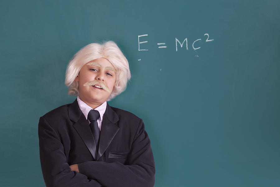 Portrait of boy dressed as Einstein with maths equation Photograph by IndiaPix/IndiaPicture