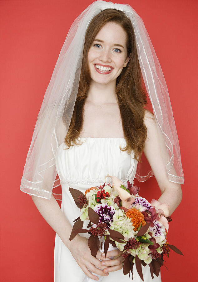 Portrait of bride with red background Photograph by Jamie Grill