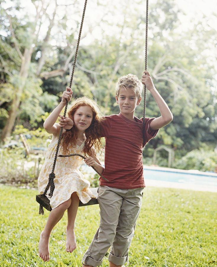 Portrait of Brother and Sister By a Swing Photograph by Digital Vision.