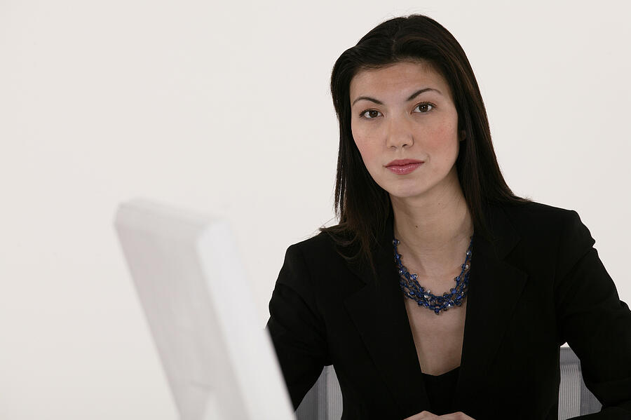 Portrait of businesswoman at computer Photograph by Comstock Images