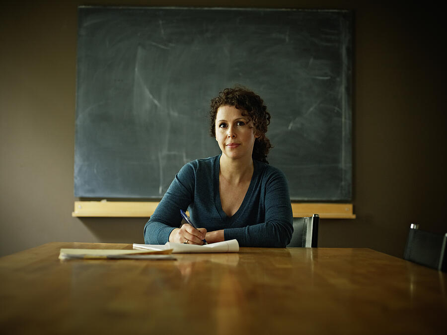 Portrait of businesswoman at conference room table Photograph by Thomas Barwick