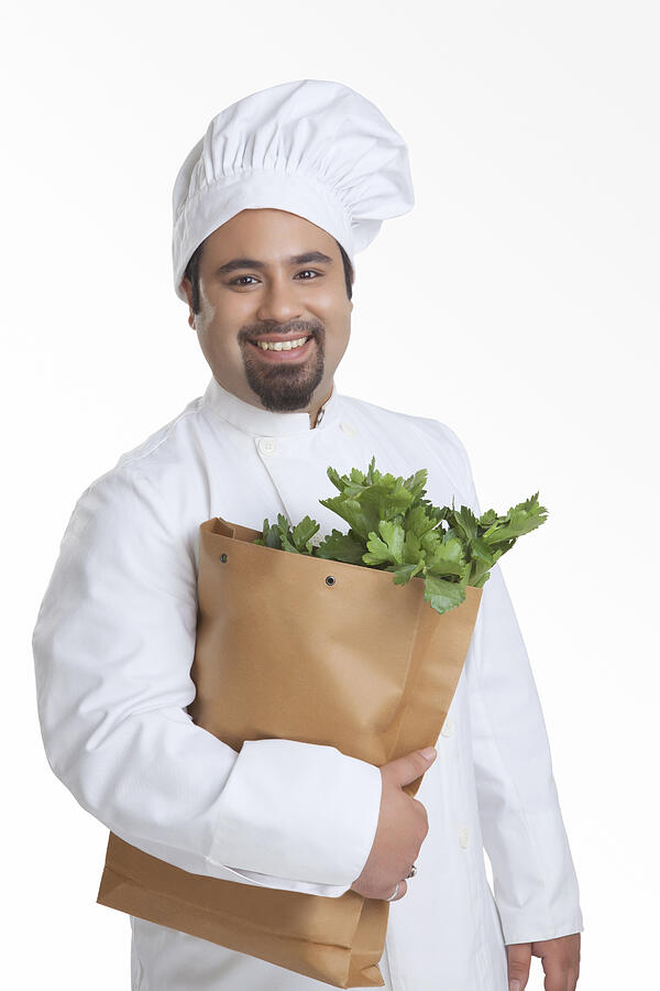 Portrait of chef with bag of vegetables Photograph by IndiaPix/IndiaPicture