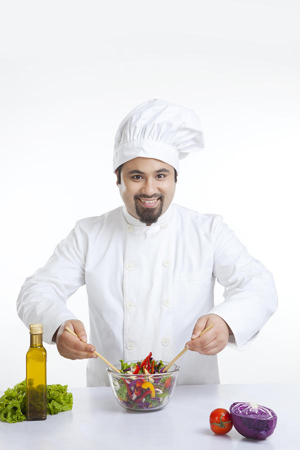 Portrait of chef with vegetables in bowl Photograph by IndiaPix/IndiaPicture