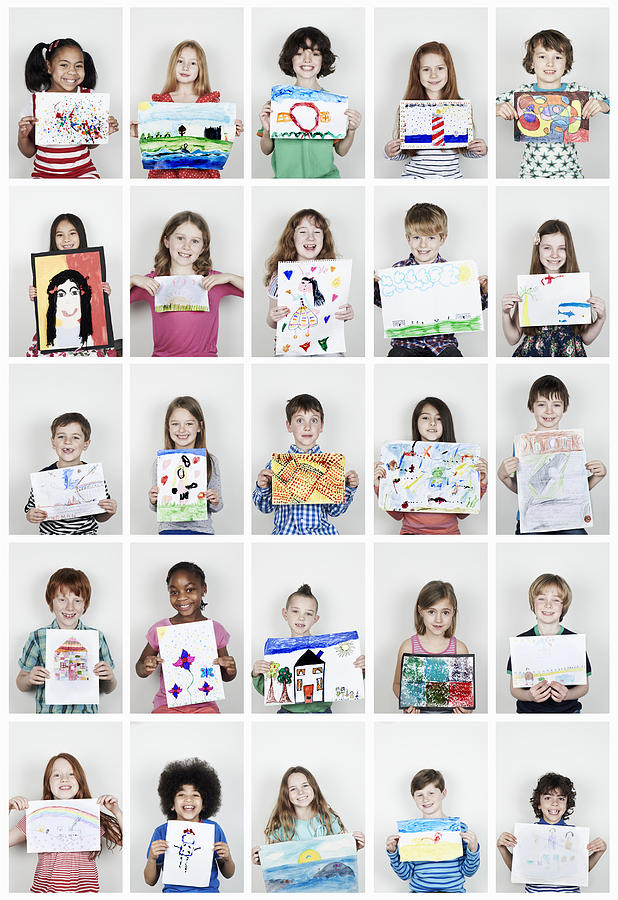 Portrait of children holding their art work Photograph by Flashpop