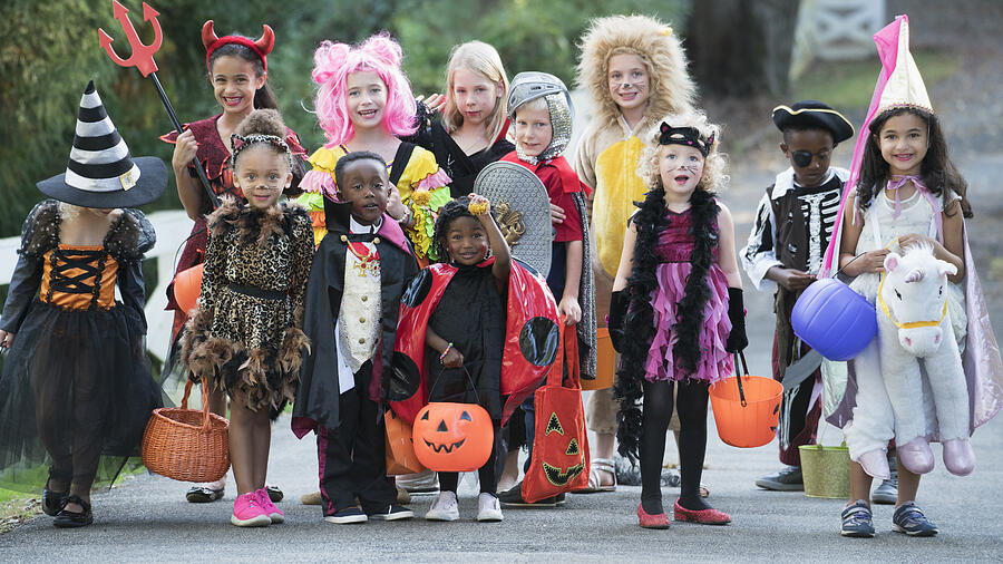 Portrait of children wearing costumes on Halloween Photograph by Ariel Skelley