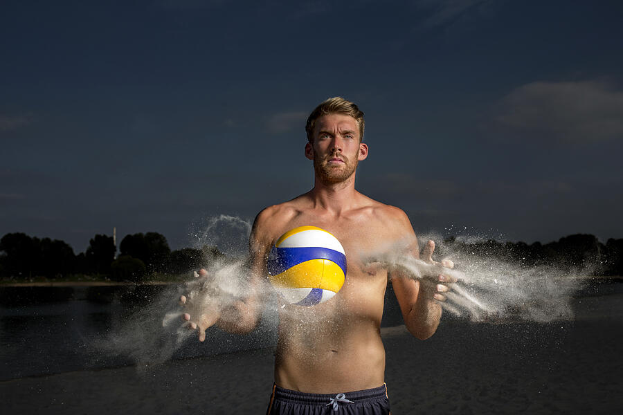 Portrait of confident beach volleyball player cleaning the ball Photograph by Tomas Rodriguez