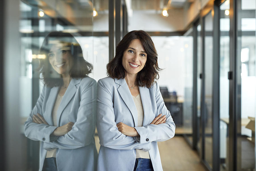 Portrait of confident businesswoman in office Photograph by Morsa Images